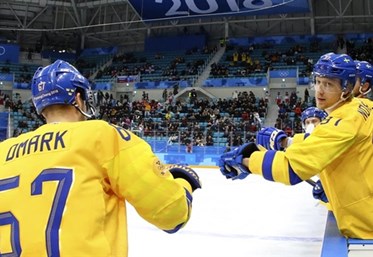 GANGNEUNG, SOUTH KOREA - FEBRUARY 15: Sweden's Linus Omark #67 celebrates at the bench with John Norman #37 after a first period goal against Norway during preliminary round action at the PyeongChang 2018 Olympic Winter Games. (Photo by Andre Ringuette/HHOF-IIHF Images)

